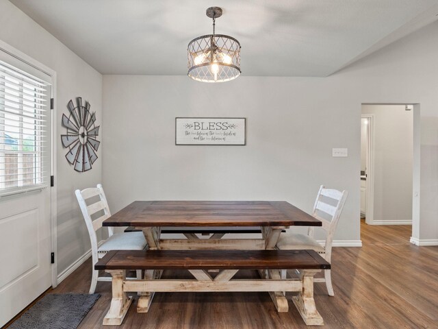 dining room featuring baseboards, a notable chandelier, and wood finished floors