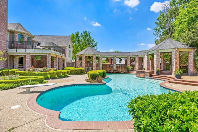 pool with a gazebo and a diving board