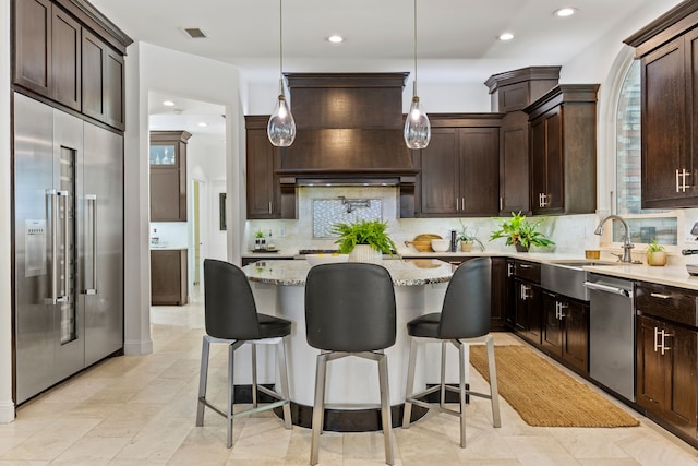 kitchen with backsplash, dark brown cabinets, visible vents, and stainless steel appliances