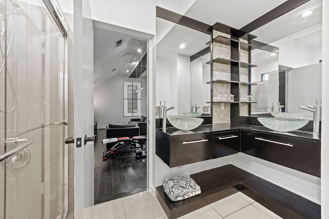 bathroom featuring a shower stall, tile patterned floors, a sink, and visible vents