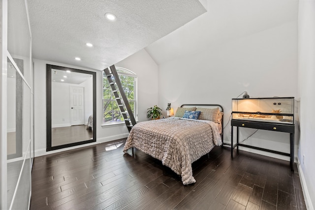 bedroom featuring recessed lighting, wood finished floors, a textured ceiling, and baseboards
