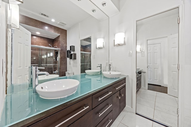 full bathroom with tile patterned flooring, visible vents, and a sink