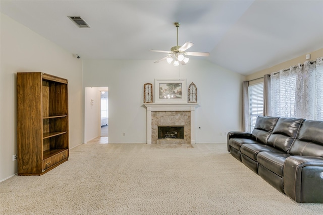 carpeted living room featuring a tile fireplace, visible vents, ceiling fan, and a healthy amount of sunlight