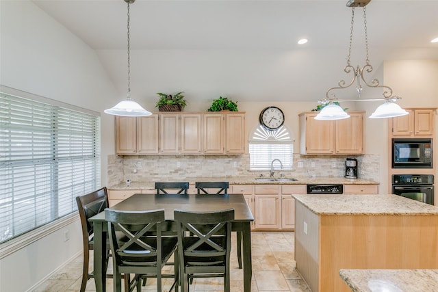 kitchen featuring light brown cabinetry, backsplash, a sink, decorative light fixtures, and black appliances