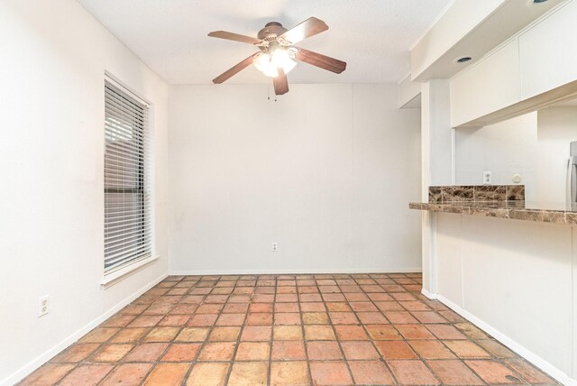 unfurnished room with a ceiling fan