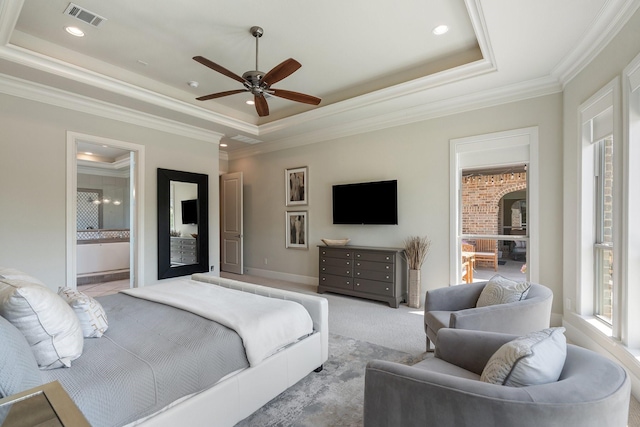 bedroom with crown molding, visible vents, and a raised ceiling