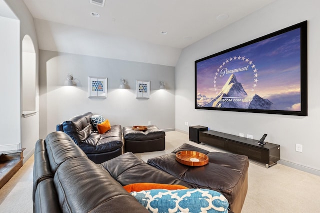 carpeted home theater featuring visible vents and baseboards