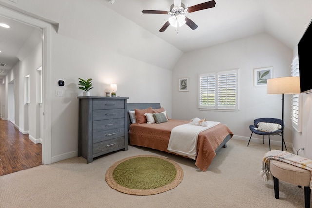 bedroom with light colored carpet, lofted ceiling, a ceiling fan, and baseboards