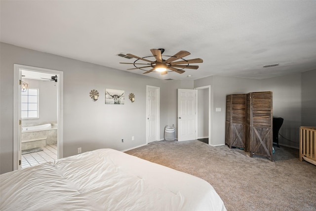 carpeted bedroom with ceiling fan, visible vents, baseboards, and ensuite bathroom