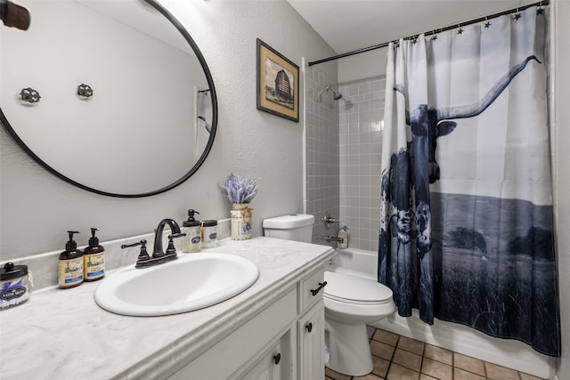 bathroom featuring tile patterned floors, shower / bath combination with curtain, a textured wall, toilet, and vanity