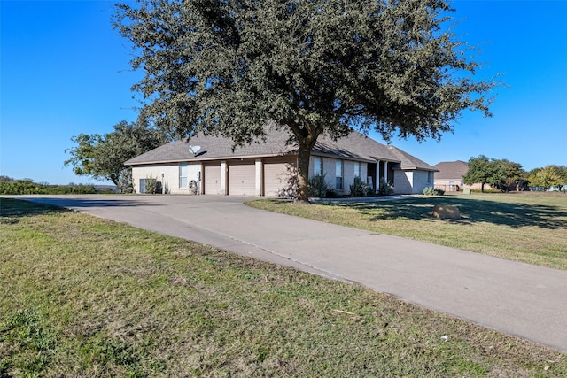 single story home with a front yard, driveway, and an attached garage