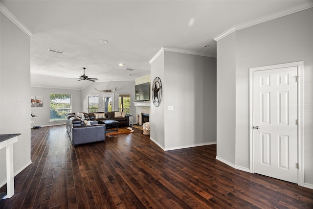 living room with visible vents, hardwood / wood-style floors, ornamental molding, a fireplace, and a ceiling fan