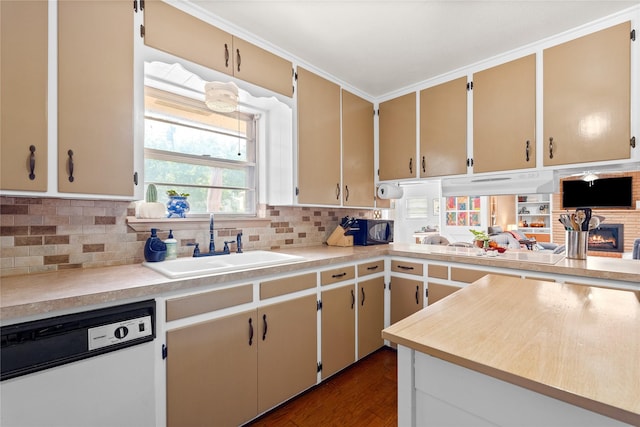 kitchen with light countertops, a sink, decorative backsplash, black microwave, and dishwasher