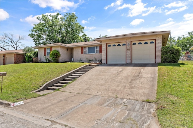 ranch-style house featuring brick siding, an attached garage, driveway, and a front lawn