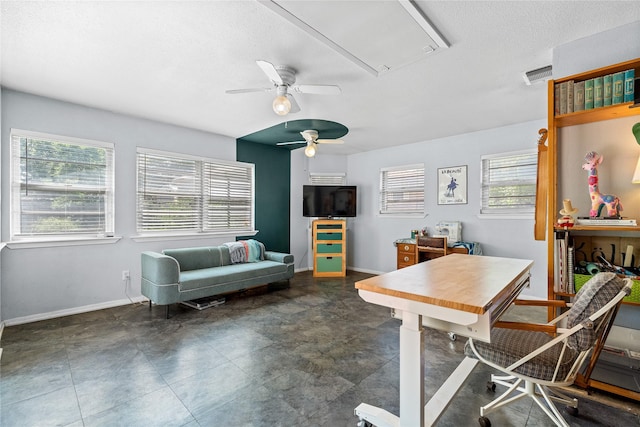 office area featuring attic access, a ceiling fan, baseboards, and a healthy amount of sunlight