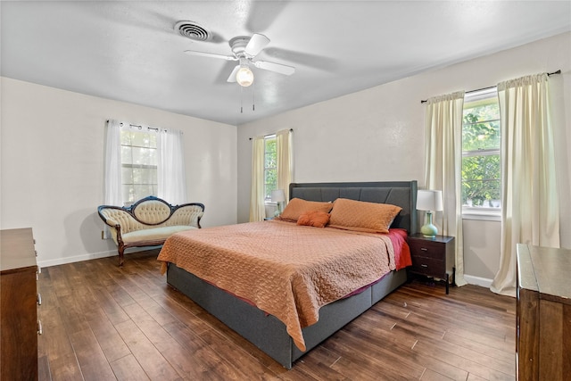 bedroom featuring baseboards, visible vents, and dark wood-style floors
