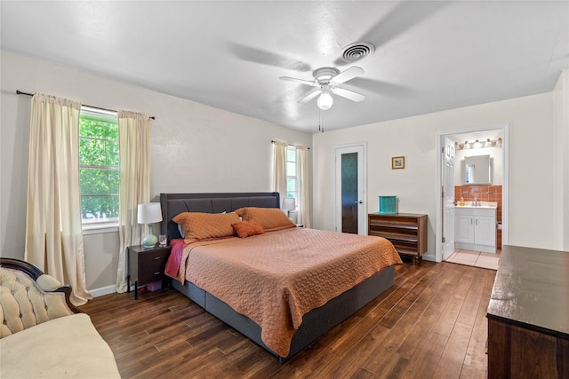 bedroom featuring visible vents, dark wood-style floors, and multiple windows