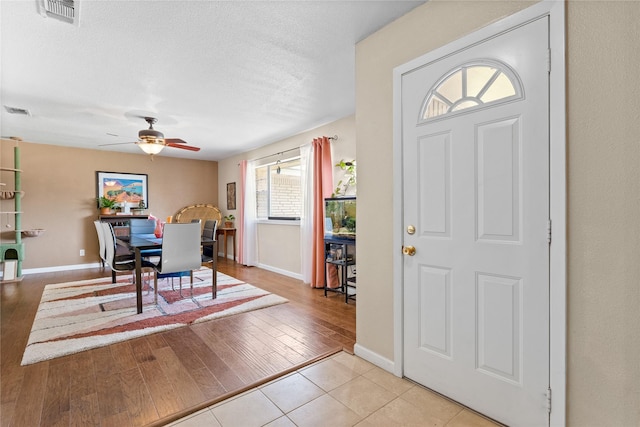 entrance foyer featuring visible vents, light wood finished floors, baseboards, and ceiling fan