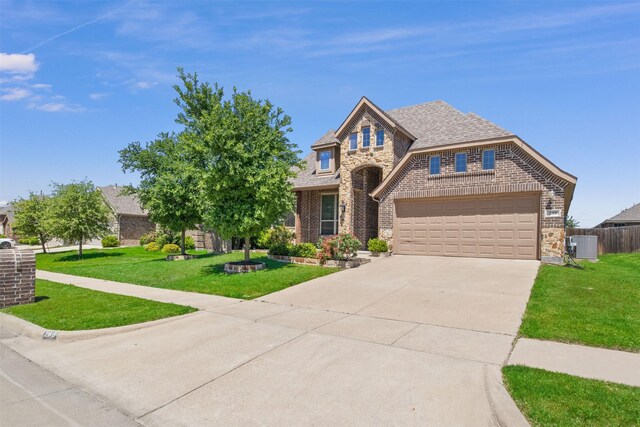 248 Van Buren Dr, Forney, TX 75126 - view of front of house featuring stone siding, brick siding, concrete driveway, and a garage