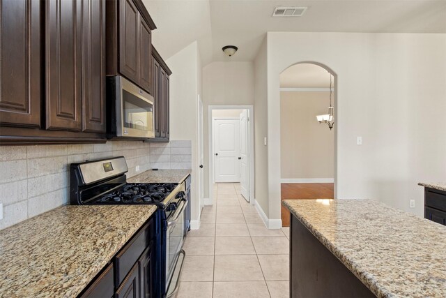 248 Van Buren Dr, Forney, TX 75126 - kitchen featuring stainless steel dishwasher, a sink, a kitchen island, light tile patterned floors, and light stone counters