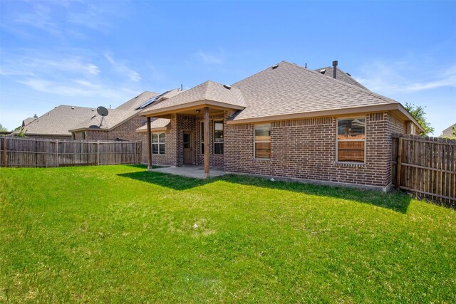 248 Van Buren Dr, Forney, TX 75126 - back of house featuring brick siding, roof with shingles, and a patio area