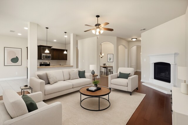 248 Van Buren Dr, Forney, TX 75126 - unfurnished living room with ceiling fan, dark wood-type flooring, arched walkways, and baseboards