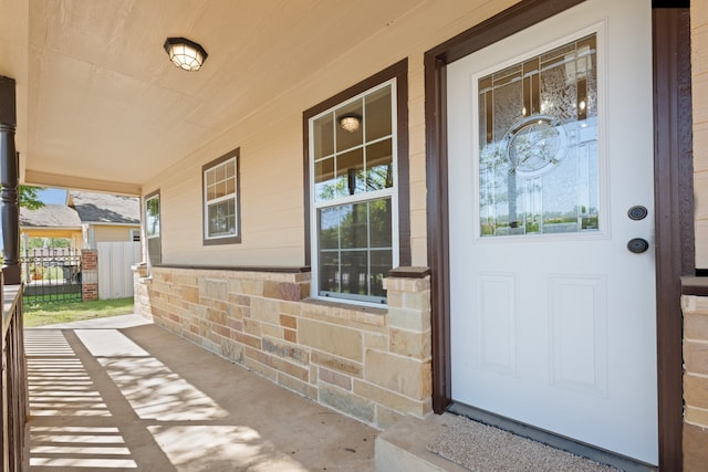 view of exterior entry with a porch