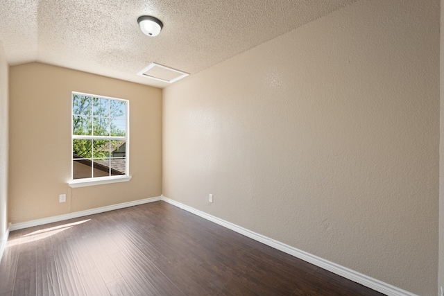 unfurnished room with baseboards, dark wood-style flooring, and a textured ceiling