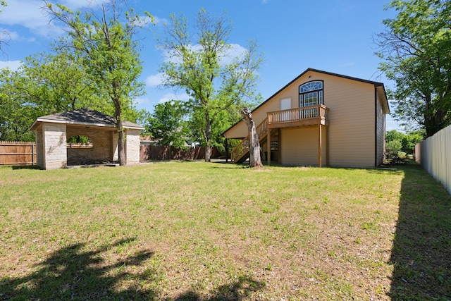 view of yard featuring a wooden deck, a fenced backyard, and stairs