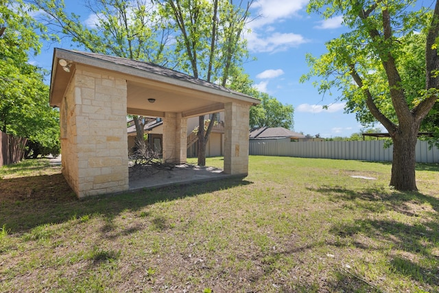 view of yard featuring fence and a patio area
