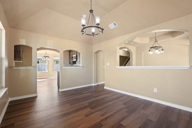 unfurnished dining area featuring visible vents, an inviting chandelier, and dark wood-type flooring