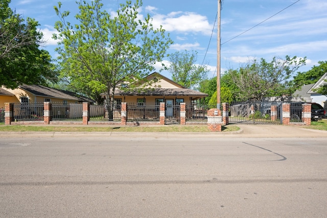 bungalow-style home with a gate and a fenced front yard