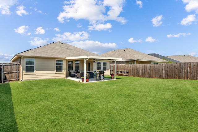 rear view of house with a lawn, a ceiling fan, a fenced backyard, and a patio