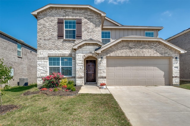 view of front facade featuring central AC unit, concrete driveway, a front lawn, stone siding, and an attached garage