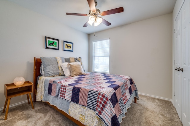 bedroom featuring a ceiling fan, baseboards, carpet floors, and a closet
