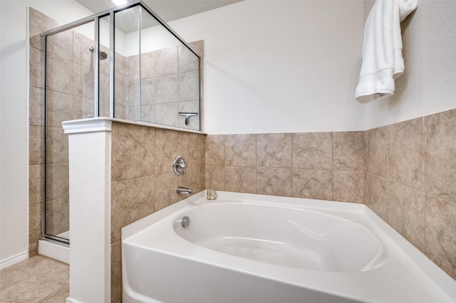 bathroom with a bath and a stall shower