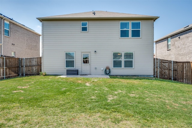 back of property with a lawn, a fenced backyard, and a patio