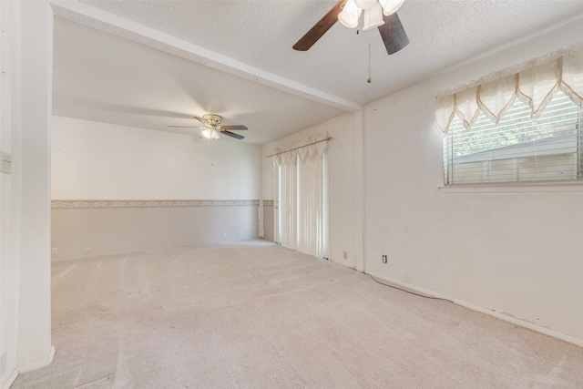 carpeted empty room with a textured ceiling and ceiling fan