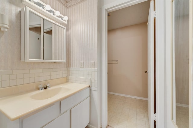 bathroom with baseboards and vanity