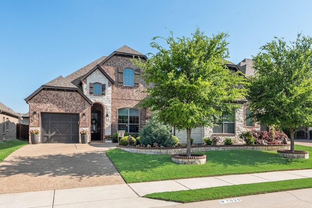 view of front facade with concrete driveway, a front lawn, brick siding, and an attached garage