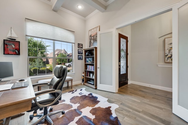 office area with beamed ceiling, light wood-style flooring, baseboards, and crown molding