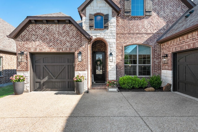 view of front of home with brick siding, a garage, and concrete driveway