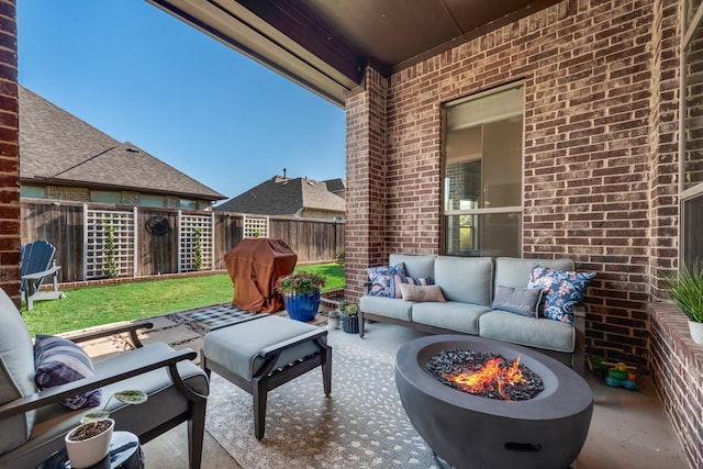 view of patio featuring a fenced backyard and an outdoor living space with a fire pit