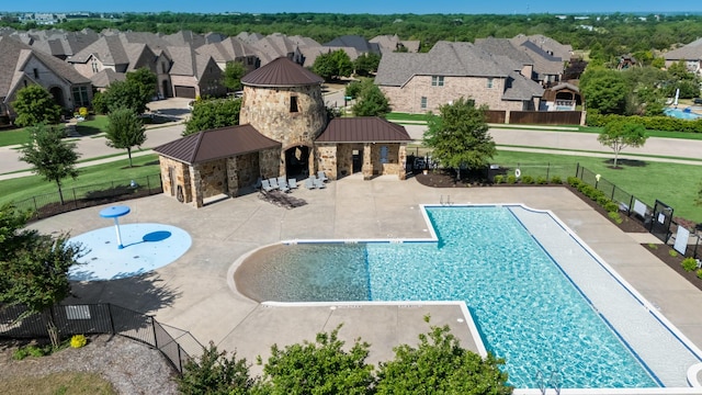pool with fence, a residential view, a patio area, a lawn, and a gazebo