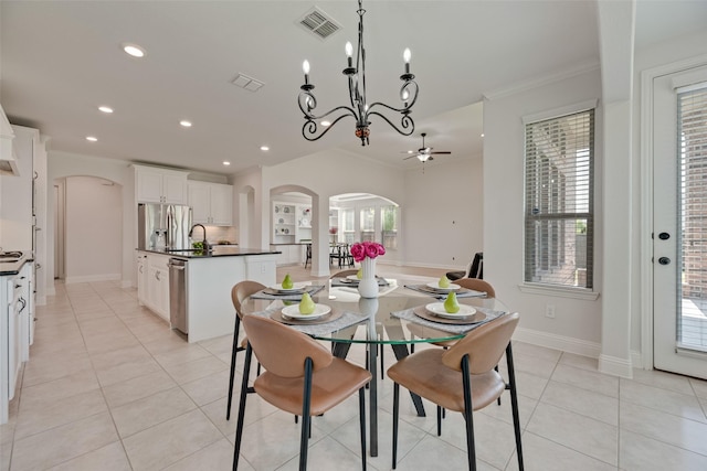 dining room featuring recessed lighting, arched walkways, ceiling fan with notable chandelier, and ornamental molding