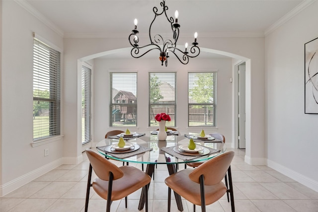 dining room featuring crown molding, arched walkways, light tile patterned floors, and a notable chandelier