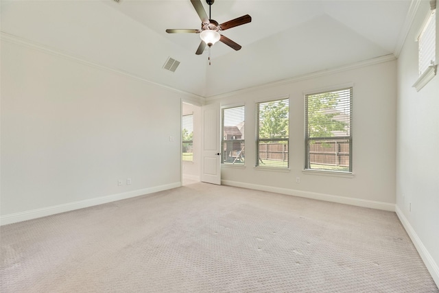 unfurnished room with ceiling fan, light colored carpet, crown molding, visible vents, and baseboards