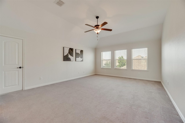 unfurnished room featuring visible vents, lofted ceiling, baseboards, light colored carpet, and a ceiling fan