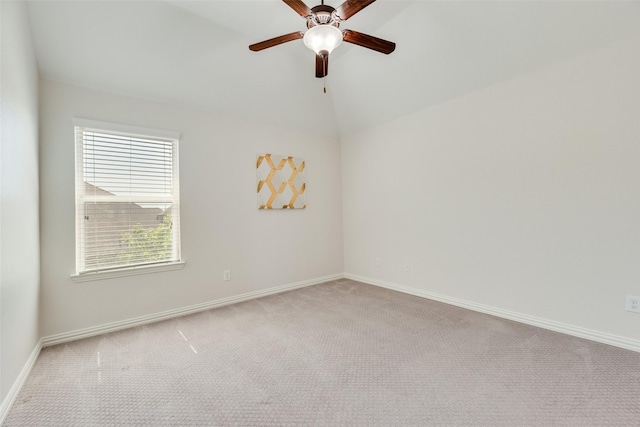 carpeted spare room featuring baseboards, a ceiling fan, and lofted ceiling
