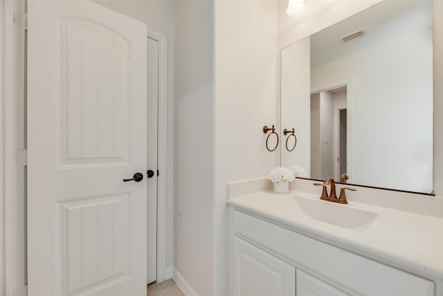 bathroom with baseboards, visible vents, and vanity